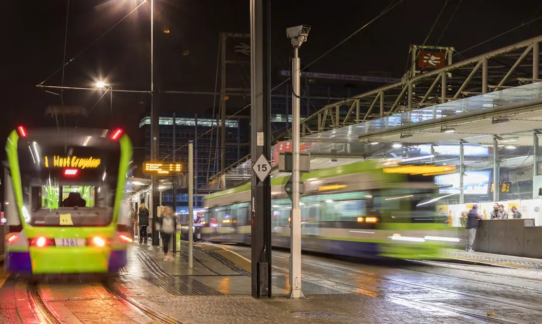 Tram passing through central Croydon at night