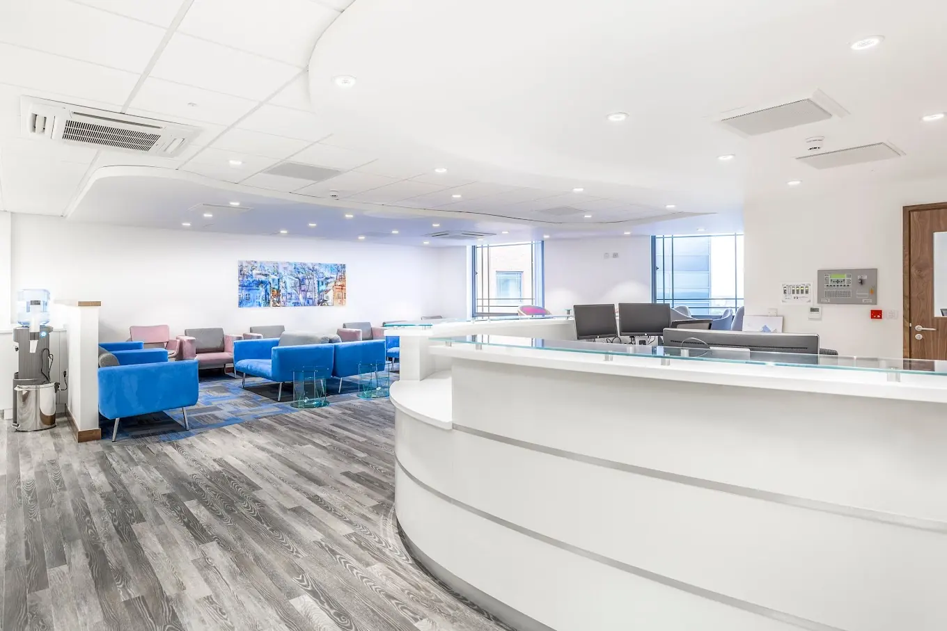 Bright medical reception with curved desk and waiting area