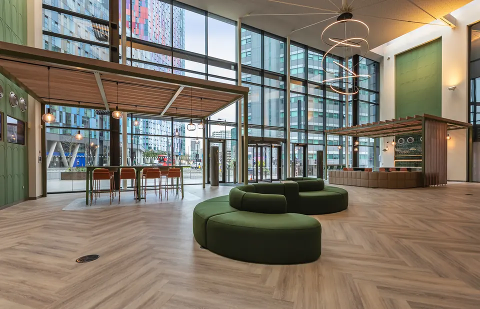 Refurbished reception with circular seating beneath the glazed atrium