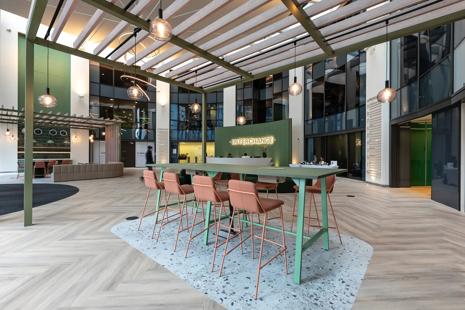 The refurbished triple-height reception with lounge seating, pergola and café tables